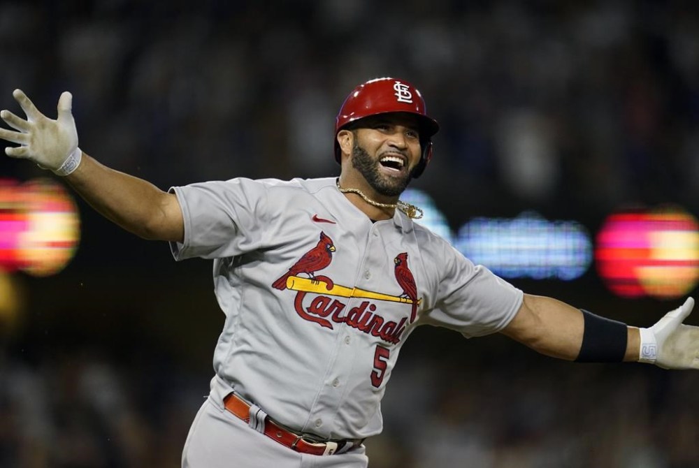 FILE - St. Louis Cardinals designated hitter Albert Pujols reacts after hitting his 700th career home run during the fourth inning of a baseball game against the Los Angeles Dodgers in Los Angeles, Sept. 23, 2022. Pujols was hired Monday, June 5, 2023, by Major League Baseball as a special assistant to Commissioner Rob Manfred. Pujols will consult on issues related to his native Dominican Republic, among other areas. He also will start work Tuesday as an MLB Network analyst. (AP Photo/Ashley Landis, File)
