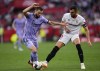 Real Madrid's Nacho, left, challenges for the ball with Sevilla's Joan Jordan during a Spanish La Liga soccer match between Sevilla and Real Madrid at the Ramon Sanchez Pizjuan stadium in Seville, Spain, Saturday, May 27, 2023. (AP Photo/Jose Breton)