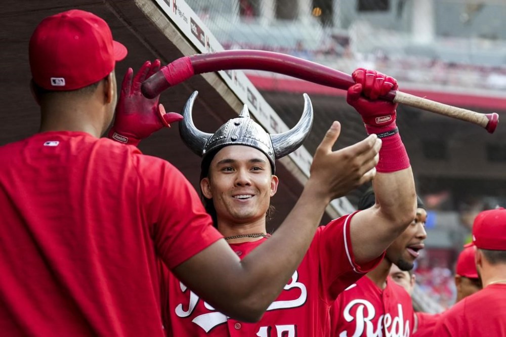 Cincinnati Reds' Stuart Fairchild celebrates in the dugout after hitting a solo home run during the third inning of a baseball game against the Milwaukee Brewers in Cincinnati, Monday, June 5, 2023. (AP Photo/Aaron Doster)