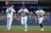 Miami Marlins shortstop Joey Wendle (18) left fielder Bryan De La Cruz, center, and center fielder Jonathan Davis celebrate after the Marlins beat the Kansas City Royals 6-1 in a baseball game, Tuesday, June 6, 2023, in Miami. (AP Photo/Wilfredo Lee)