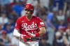 Cincinnati Reds' Curt Casali reacts after drawing a bases-loaded walk during the ninth inning of the team's baseball game against the Los Angeles Dodgers in Cincinnati, Tuesday, June 6, 2023. (AP Photo/Aaron Doster)