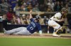 Seattle Mariners' Ty France (23) scores from second base off a single by Teoscar Hernandez as San Diego Padres catcher Austin Nola waits for the throw during the eighth inning of a baseball game Tuesday, June 6, 2023, in San Diego. (AP Photo/Gregory Bull)