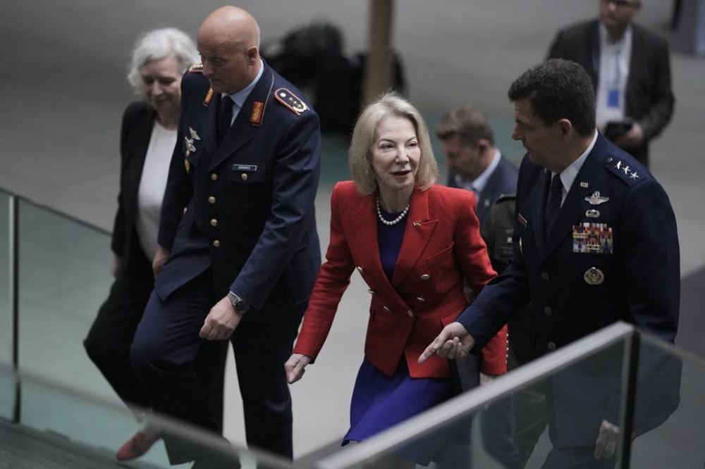 United States Ambassador to Germany Amy Gutmann, center, German air force chief Lieutenant General Ingo Gerhartz, left, and U.S. Air National Guard Director Lieutenant General Michael A. Loh, right, arrive for a news conference on the Air Defender military exercise in Berlin, Germany, Wednesday, June 7, 2023. (AP Photo/Markus Schreiber)