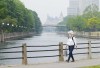 A person wears a mask as they walk along the Rideau Canal in Ottawa on Wednesday, June 7, 2023. Forest fire smoke continues to shroud the nation's capital, triggering air quality advisories. THE CANADIAN PRESS/Sean Kilpatrick