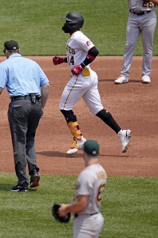 Pittsburgh Pirates' Rodolfo Castro, center, rounds the bases after hitting a solo home run off Oakland Athletics starting pitcher Hogan Harris, bottom, during the second inning of a baseball game in Pittsburgh, Wednesday, June 7, 2023. (AP Photo/Gene J. Puskar)