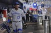 Kansas City Royals catcher Salvador Perez smiles as he walks through the dugout before the team's baseball game against the Miami Marlins, Wednesday, June 7, 2023, in Miami. (AP Photo/Peter Joneleit)