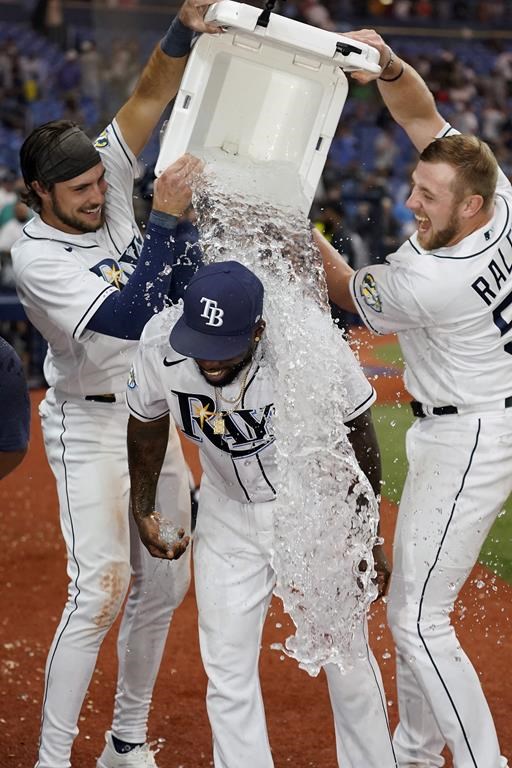 Tampa Bay Rays' Randy Arozarena, center, gets doused with ice water by Josh Lowe, left, and Luke Raley, right, after his walk-off home run off Minnesota Twins relief pitcher Jhoan Duran during the ninth inning of a baseball game Wednesday, June 7, 2023, in St. Petersburg, Fla. (AP Photo/Chris O'Meara)