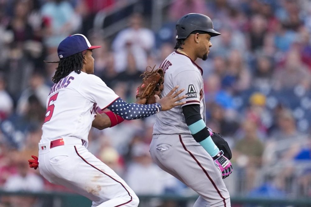 Washington Nationals shortstop CJ Abrams tags out Arizona Diamondbacks Ketel Marte during a rundown between first and second base, during the fourth inning of a baseball game at Nationals Park, Wednesday, June 7, 2023, in Washington. (AP Photo/Alex Brandon)