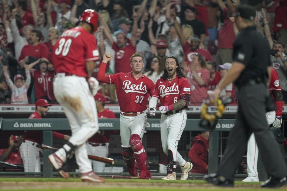 Cincinnati Reds' Will Benson (30) celebrates with Tyler Stephenson (37) and Jonathan India (6) after hitting a walk-off, two-run home run against the Los Angeles Dodgers in the ninth inning of a baseball game in Cincinnati, Wednesday, June 7, 2023. This was Benson's first major league home run (AP Photo/Jeff Dean)