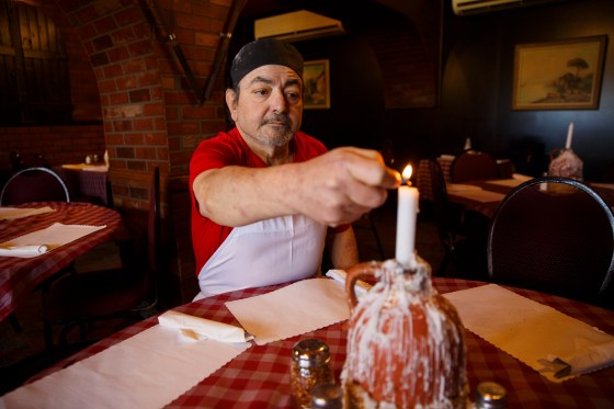 Frank Grande of Casa Grande lights a candle at his Sargent Avenue eatery. Oh, to have just one more basket of the fried dough with tomato sauce. (Mike Deal / Winnipeg Free Press files)