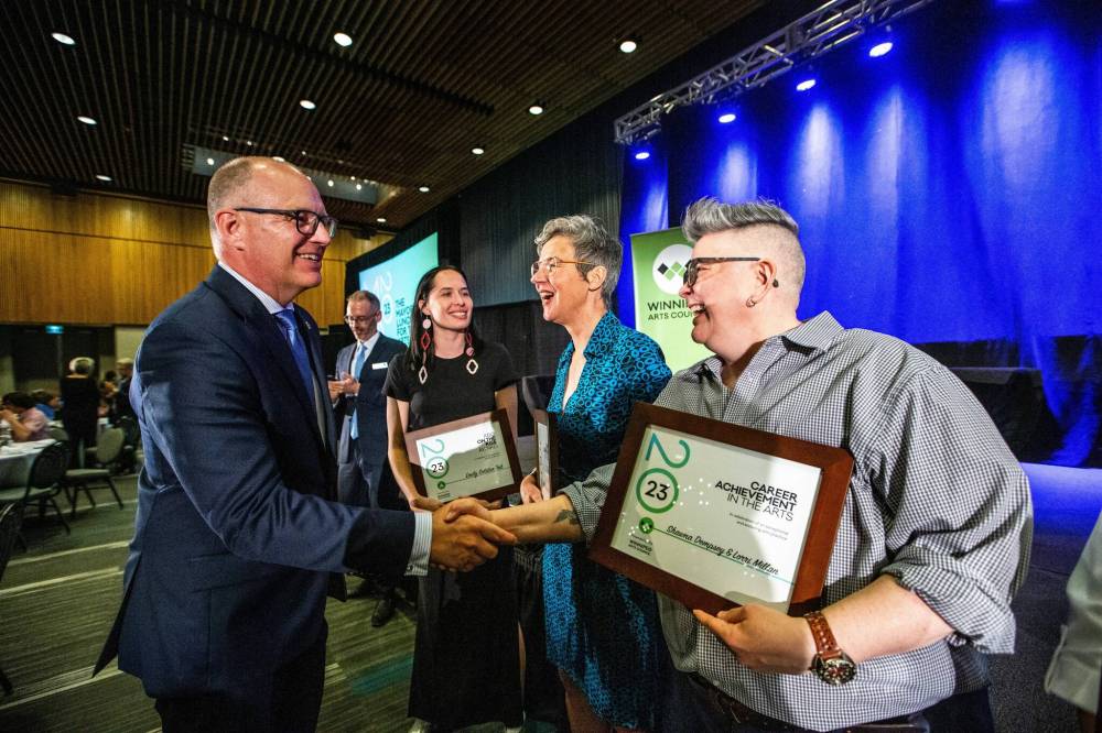 MIKAELA MACKENZIE / WINNIPEG FREE PRESS
                                Mayor Scott Gillingham shakes Lorri Millan’s hand as Emily Solstice Tait (left) and Shawna Dempsey share a laugh at the Mayor’s Luncheon for the Arts at the RBC Convention Centre Thursday.