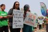 Medical laboratory technologists Holly Johnson (left) and Sarah Peters were among the more than 100 Manitoba Association of Health Care Professionals who rallied on legislature grounds May 16 amid protracted contract negotiations with Shared Health. (Tyler Searle / Winnipeg Free Press)