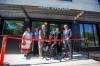 Izzy Parisian, a new resident at 390 Ross, cuts a red ribbon to officially open the building. He was accompanied by (from left): Jaime Grasby, Jason Whitford, John Pollard, Families Minister Rochelle Squires, and Mayor Scott Gillingham. (Mike Deal / Winnipeg Free Press)