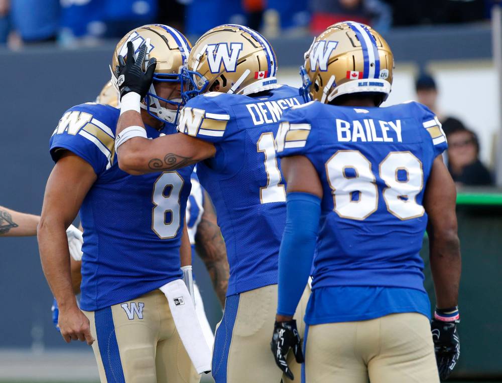 THE CANADIAN PRESS/John Woods
Winnipeg Blue Bombers quarterback Zach Collaros (8) and Nic Demski (10) celebrate Demski’s touchdown against the Hamilton Tiger-Cats during first half CFL action in Winnipeg Friday.