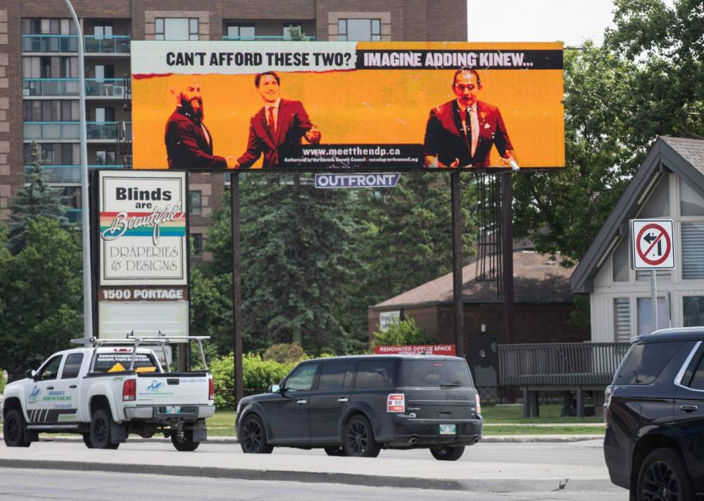 A political attack ad near Polo Park featuring Justin Trudeau, Jagmeet Singh and Wab Kinew. (Jessica Lee / Winnipeg Free Press files)