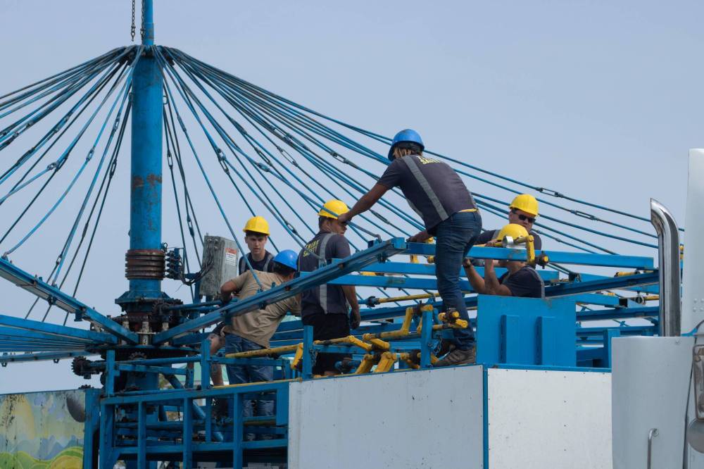 Contractors set up a ride at the Red River Ex. The Ex will be spending twice as much as usual on security this year, following a shooting incident last summer. (Mike Thiessen / Winnipeg Free Press)
