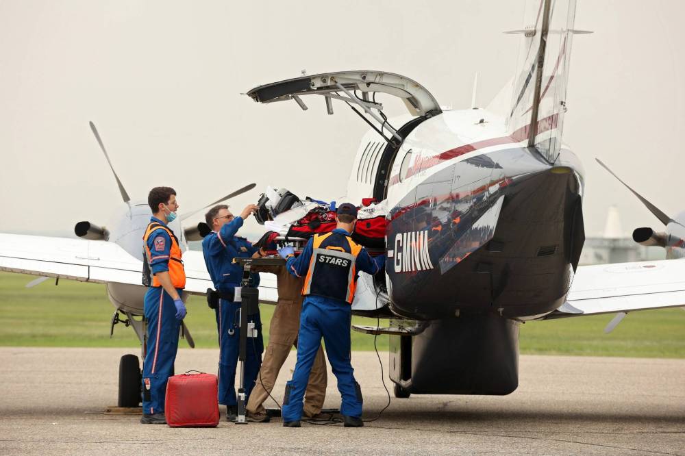 A critical care team loads a victim of the Trans-Canada Highway crash into a plane for transport to the Health Sciences Centre in Winnipeg at the Brandon Municipal Airport on Thursday. (Tim Smith/The Brandon Sun)