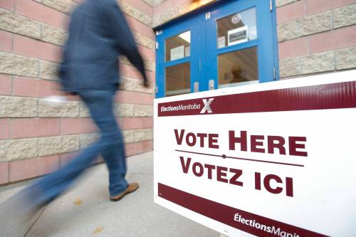 THE CANADIAN PRESS FILES/John Woods
                                A voter walks into the polling station to vote in the Manitoba election in Winnipeg, Tuesday, October 4, 2011.