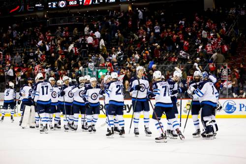Winnipeg Jets players celebrate their victory against New Jersey Devils at the end of an NHL hockey game Thursday, March 10, 2022, in Newark, N.J. The Jets won 2-1. (AP Photo/Eduardo Munoz Alvarez)
                                Winnipeg Jets players celebrate their victory against New Jersey Devils at the end of an NHL hockey game Thursday, March 10, 2022, in Newark, N.J. The Jets won 2-1. (AP Photo/Eduardo Munoz Alvarez)