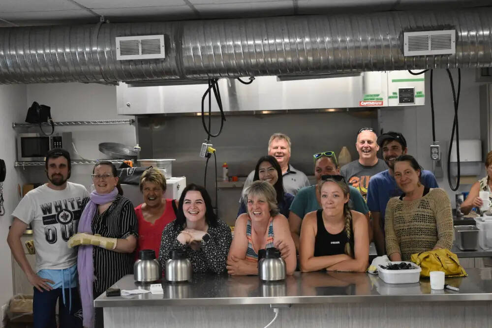 Volunteers join Candace Richardson (second from left) and her fiancé, Scott McMunn (far left), after the fundraiser. (Geena Mortfield / Brandon Sun)