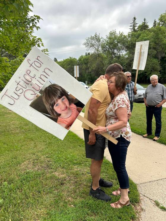 Gaylene Dutchyshen embraces her son, Justin Dutchyshen, before the decision hearing at the Dauphin courthouse. (Tyler Searle / Winnipeg Free Press)