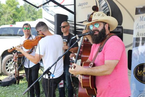 Kyle Darbyson/The Brandon Sun
                                Quinton Blair, right, performs alongside members of his band at the Dauphin Countryfest campgrounds on Friday morning.