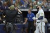 Home plate umpire Adam Hamari ejects Milwaukee Brewers' Jesse Winker (33) after he argued a clock violation during the eighth inning of a baseball game against the Tampa Bay Rays Saturday, May 20, 2023, in St. Petersburg, Fla. (AP Photo/Chris O'Meara)