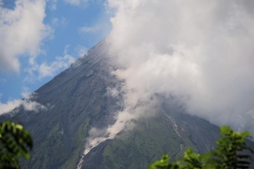 Mayon Volcano spews white smoke as seen from Daraga, Albay province, central Philippines on Thursday June 8, 2023. The Philippine Institute of Volcanology and Seismology raised Thursday the status of Mayon Volcano in Albay to Alert Level 3 due to 