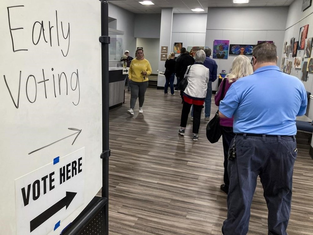FILE - People wait in line to early vote for the U.S. Senate runoff election in Georgia between Sen. Raphael Warnock and challenger Herschel Walker, on Nov. 28, 2022, in Kennesaw, Ga., near Atlanta. After years of criticizing mail voting and trying to ban so-called