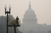 Workers finish tending a street lamp as smoke from Canadian wildfires obscures the view of the U.S. Capitol Building in Washington, Thursday, June 8, 2023. The haze from the wildfires is taking its toll on outdoor workers along the Eastern U.S. who carried on with their jobs even as dystopian orange skies forced the cancelation of sports events, school field trips and Broadway plays. (AP Photo/Susan Walsh)