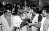 FILE - New York Cosmos star Pele kisses a trophy held up by team captain Werner Roth at New York's Kennedy Airport on Aug. 29, 1977, as the team returned after winning the North American Soccer League Championship. After two decades competing against Real Madrid, Manchester United and Brazil, Lionel Messi will be going against the NFL, Major League Baseball and the NBA. (AP Photo, File)