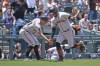 San Francisco Giants third base coach Mark Hallberg and Thairo Estrada celebrate a home run in the first inning of a baseball game against the Colorado Rockies Thursday, June 8, 2023, in Denver. (AP Photo/Geneva Heffernan)