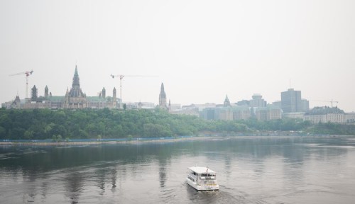 Downtown Ottawa is seen blanketed in smoke from wildfires on Monday, June 5, 2023. Raging wildfires and smoky skies across much of Canada have put a damper on travel and tourism plans this summer resulting in cancelled plans and closed businesses. THE CANADIAN PRESS/Spencer Colby
