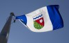 The Northwest Territories provincial flag flies on a flagpole in Ottawa, Monday July 6, 2020. An out-of-control wildfire burning near Sambaa K'e in the Northwest Territories has destroyed two cabins. THE CANADIAN PRESS/Adrian Wyld