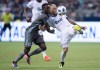 Vancouver Whitecaps' Marcel de Jong, right, kicks the ball away from Minnesota United's Abu Danladi during the second half of an MLS soccer game in Vancouver, on Saturday July 28, 2018. CF Montreal hopes to cap off a run of 11 games in just 36 days with a win against visiting Minnesota United on Saturday. THE CANADIAN PRESS/Darryl Dyck