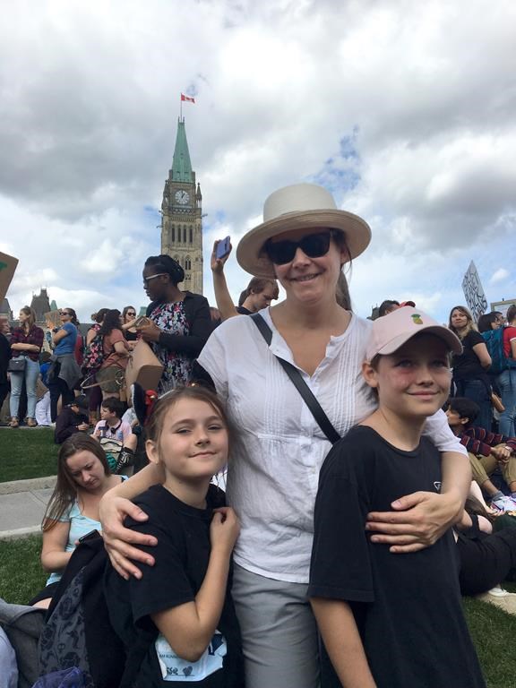 Jennifer Austin is pictured with her children, Izzy and James, at a climate strike event in Ottawa on Friday, Sept. 27, 2019 in a family handout photo. Austin is one of many Canadians dealing with climate anxiety as wildfire smoke enveloped large swaths of Canada. THE CANADIAN PRESS/HO, Jennifer Austin *MANDATORY CREDIT*