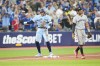 Toronto Blue Jays' George Springer (4) celebrates beside Minnesota Twins third baseman Royce Lewis (23) after coming in for a pinch hit RBI double during the sixth inning of MLB American League baseball action in Toronto on Friday, June 9, 2023. THE CANADIAN PRESS/Mark Blinch