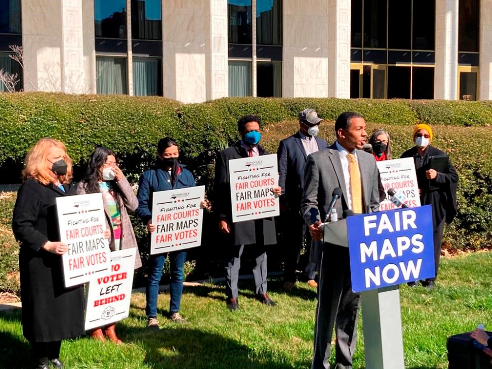 FILE - Reggie Weaver, at podium, speaks outside the Legislative Building in Raleigh, N.C, on Feb. 15, 2022, about a recent partisan gerrymandering ruling by the North Carolina Supreme Court. The U.S. Supreme Court ruled Thursday, June 8, 2023, that Alabama’s U.S. House districts violated the federal Voting Rights Act by diluting the political power of Black voters.(AP Photo/Gary D. Robertson, File)