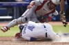 Toronto Blue Jays George Springer (4) dives for home plate and collides with Minnesota Twins catcher Ryan Jeffers (27) during fifth inning American League MLB baseball action in Toronto on Saturday, June 10, 2023. THE CANADIAN PRESS/Arlyn McAdorey