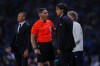 A referee talks to Inter Milan's head coach Simone Inzaghi during the Champions League final soccer match between Manchester City and Inter Milan at the Ataturk Olympic Stadium in Istanbul, Turkey, Saturday, June 10, 2023. (AP Photo/Manu Fernandez)