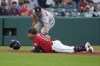 Cleveland Guardians' Josh Naylor (22) slides safely into second base under the tag of Houston Astros third baseman Alex Bregman on a double hit by Will Brennan in the seventh inning of a baseball game Saturday, June 10, 2023, in Cleveland. (AP Photo/Sue Ogrocki)