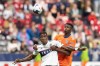 Vancouver Whitecaps' Sergio Cordova (9) and FC Cincinnati's Yerson Mosquera (15) jump for the ball during the first half of an MLS soccer match in Vancouver, on Saturday, June 10, 2023. THE CANADIAN PRESS/Ethan Cairns