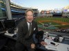 FILE - This Sept. 25, 2009 file photo shows New York Yankees broadcaster John Sterling sitting in his booth before a baseball game against the Boston Red Sox at Yankee Stadium in New York. Yankees radio broadcaster John Sterling was uninjured after he was hit by a foul ball by Justin Turner in the ninth inning of New York's 3-1 win over the Boston Red Sox on Saturday night, June 10, 2023 (AP Photo/Bill Kostroun, file)