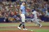 Tampa Bay Rays starting pitcher Shane McClanahan, foreground, reacts after giving up a home run to Texas Rangers' Robbie Grossman during the third inning of a baseball game Sunday, June 11, 2023, in St. Petersburg, Fla. (AP Photo/Mike Carlson)