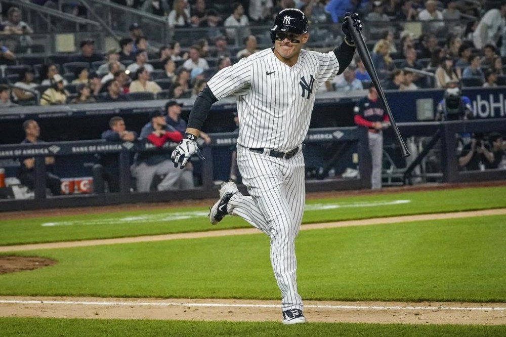 New York Yankees' Anthony Rizzo holds onto his bat as he runs towards first base after he flied out to center, during the eighth inning of a baseball game against the Boston Red Sox, Sunday, June 11, 2023, in New York. (AP Photo/Bebeto Matthews)