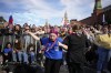 Teenagers dance as thousands of people with Russian national flags gather on Red Square to watch a concert dedicated to the Day of Russia in Moscow, Russia, Sunday, June 11, 2023. The Day of Russia is celebrated annually on 12 June. (AP Photo/Alexander Zemlianichenko)