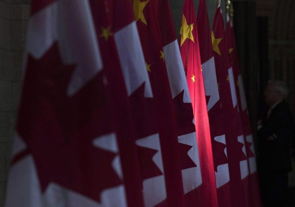 A Chinese flag is illuminated by sunshine in the Hall of Honour as Chinese Premier Li Keqiang visits Parliament Hill in Ottawa, Thursday, Sept. 22, 2016. Former Pierre Elliott Trudeau Foundation head Morris Rosenberg says concerns were never raised to him about a large donation to the charity from two Chinese businessmen connected to Beijing. THE CANADIAN PRESS/Adrian Wyld
