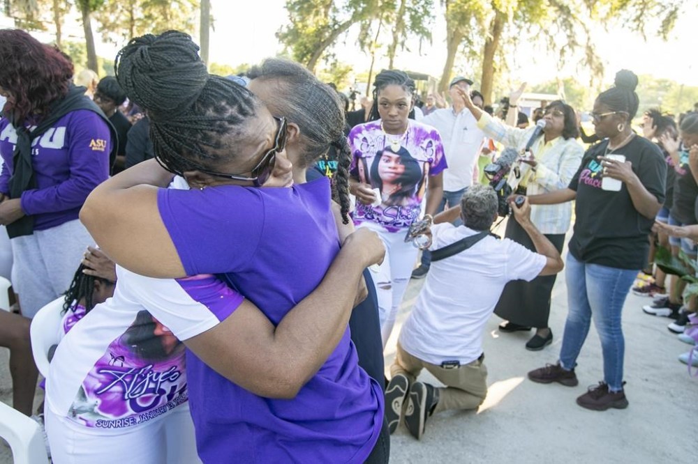Pamela Dias, front left, the mother of Ajike Owens, gets hug from a friend as mourners gather for a remembrance service at Immerse Church of Ocala for Owens, Thursday, June 8, 2023, in Ocala, Fla. Owens was fatally shot by her neighbor Susan Lorincz when she went to Lorincz's door. Lorincz was arrested and charged in the shooting. (AP Photo/Alan Youngblood)