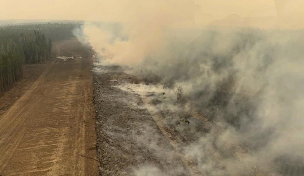 A burned section of forest in the area near Edson, Alta., smoulders, Saturday, May 6, 2023. Wildfires that forced the evacuation of the town west of Edmonton continue to menace the community, with crews also battling heavy, vision-obscuring smoke. THE CANADIAN PRESS/HO-Government of Alberta Fire Service