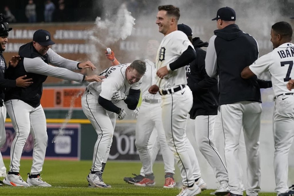 Detroit Tigers' Spencer Torkelson, center, is celebrated by teammates after the 10th inning of a baseball game against the Atlanta Braves, Monday, June 12, 2023, in Detroit. Torkelson hit the walk-off single to center to score Andy Ibanez. (AP Photo/Carlos Osorio)